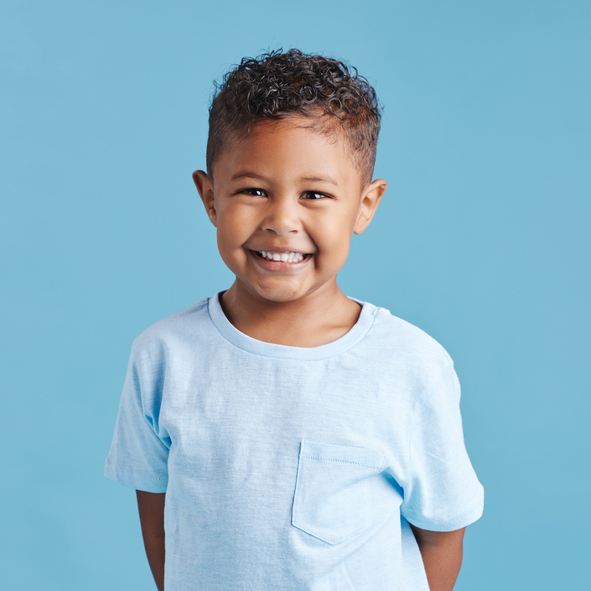 Vibrant child beaming after finishing early orthodontic treatment in Minnesota