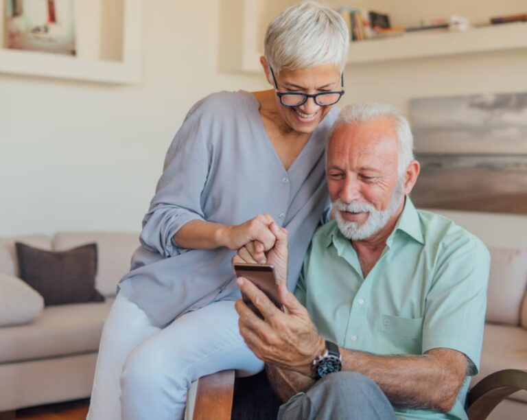 Smiling Older Couple Looking At Reviews